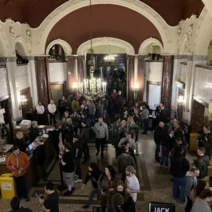 a crowd of people standing in a hall