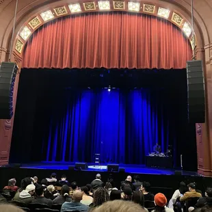 a stage with a blue curtain