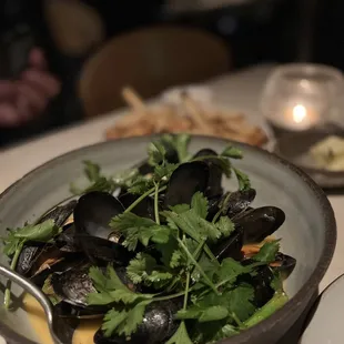 a bowl of mussels and greens