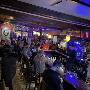 a large group of people sitting at the bar
