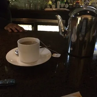 a cup of coffee and a teapot