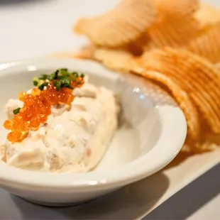 a bowl of dip and chips