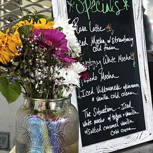 a mason jar with flowers in it