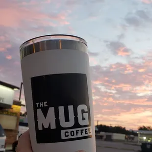 a person holding a cup of coffee