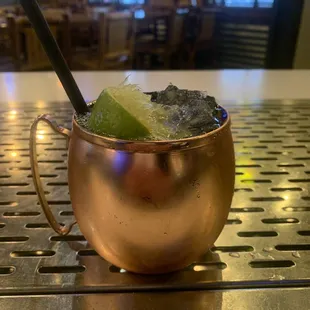 a drink in a copper mug