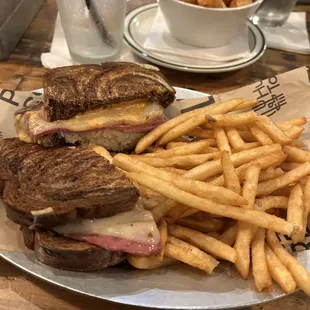 a grilled sandwich and french fries