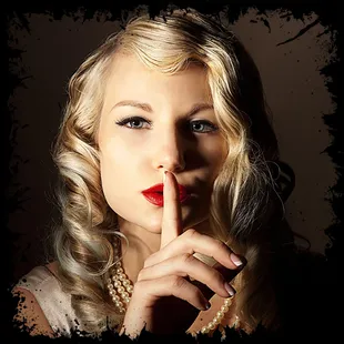 a woman with a finger on her lips