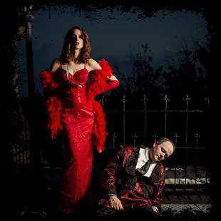 a woman in a red dress and a man in a black tuxedo