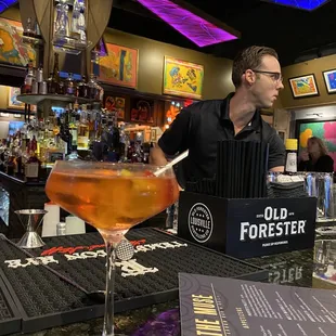 a bartender pouring a drink