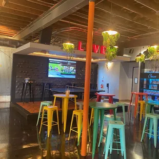 a bar with colorful stools