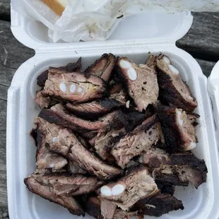 a tray of ribs and a sandwich