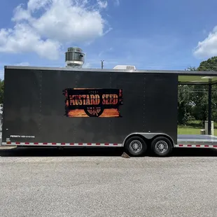 a black trailer parked in a parking lot