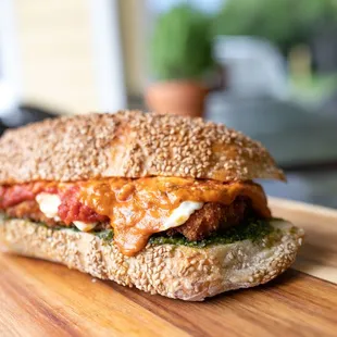 a sandwich on a wooden cutting board