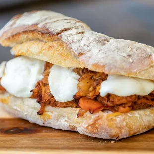 a sandwich with meat and cheese