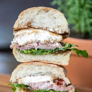 a stack of sandwiches on a cutting board