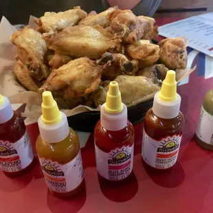 a basket of chicken wings and condiments