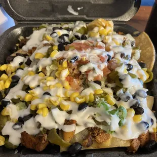 Classic nachos with chicken I added black beans, vegan cheese sauce, vegan sour cream and corn.