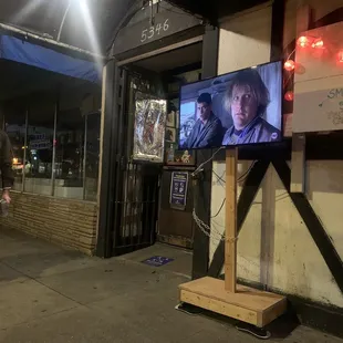 a man standing in front of a tv
