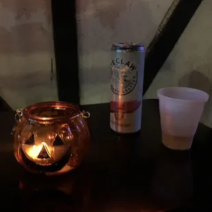 a candle and a cup on a table