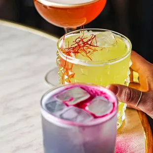 three cocktails on a table