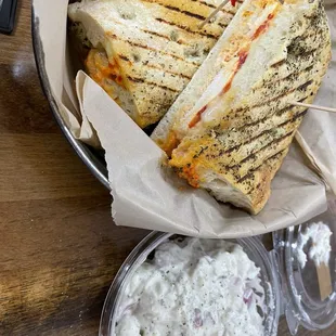 a panini with a side of potato salad