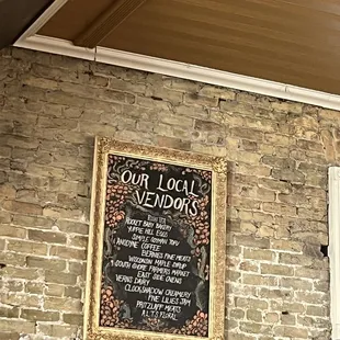 a menu on a brick wall