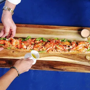 Biggest Lobster Roll in Florida, 2 ft long &amp; 2 lbs of lobster! Serves 1-4 as an entree, more as a starter. Ask about Nauti Party Packs to go