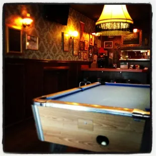 The pool table waits.