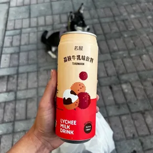 a person holding a can of drink