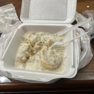 a takeout container of chicken and gravy