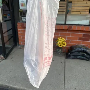 a plastic bag hanging from a pole