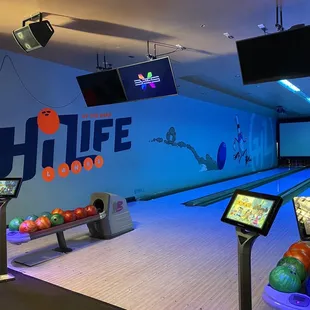 a bowling alley with several bowling balls