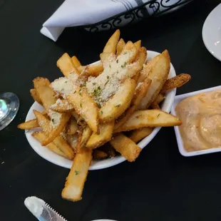Side of black truffle fries with yummy dipping sauce.