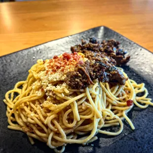 a plate of spaghetti and meat