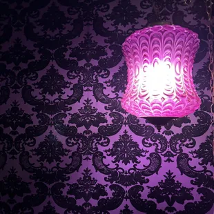 a purple lamp on a purple wall