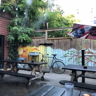 a patio with picnic tables and umbrellas