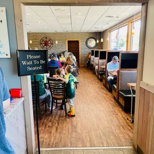 a group of people sitting at tables in a restaurant