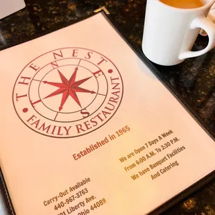 a menu and a cup of coffee