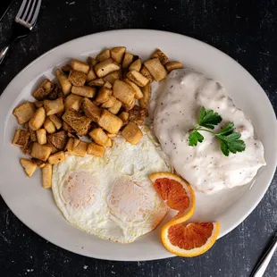 CFS- Breaded face cutlet topped w/sausage gravy, three eggs, crispy russet potatoes and toast.