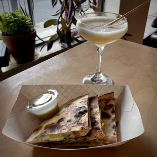 a plate of quesadillas and a drink