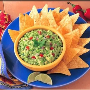 a bowl of guacamole and tortillas