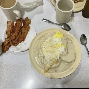 Biscuits and gravy with an over-hard egg and a side of bacon.