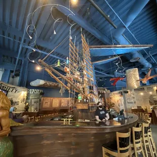 The bar is a ship, and the bartenders climb the sail to get some of the liquor