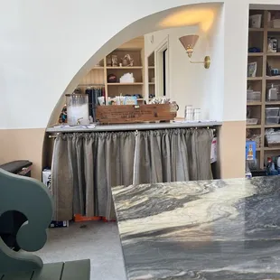 The water and utensils area, clothing items in the back.