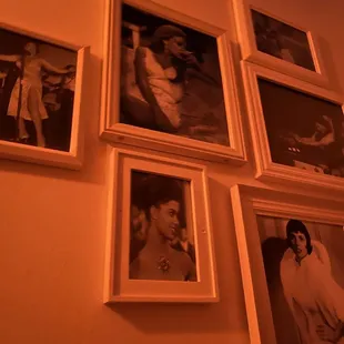 a wall of framed photographs