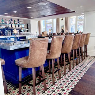 a bar with chairs and a counter