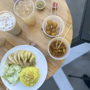 Curry fish balls , Hainan chicken and curry pork skin , accompanied by our pearl and tea drinks