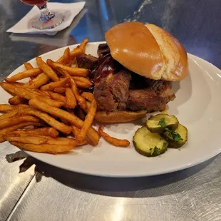 Country style smoked pork sandwich with beer fries. No coleslaw because they ran out for the night.
