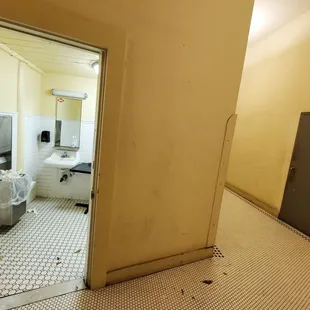 Bathroom located through the brown door.