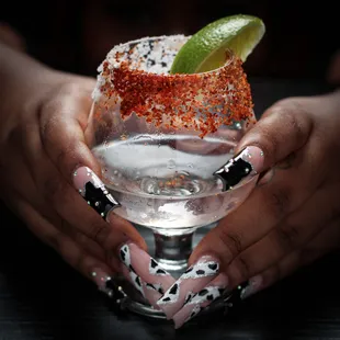 a person holding a margarita